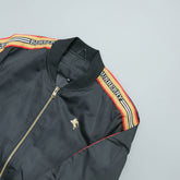 Black jacket with Burberry logo and branding on a light gray background